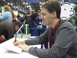 Kinney signs copies of Diary of a Wimpy Kid at the 2009 New York 