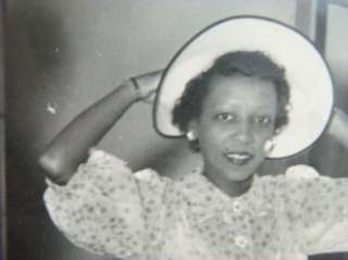 Hickman Black History 1950s Woman Putting On A Hat In A MIrror 
