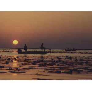 Fishermen Take in the First Rays of the Rising Sun on Lake Okeechobee 