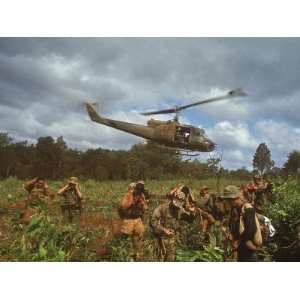  American UH1 Huey Helicopter Lifting Off as Personnel on 