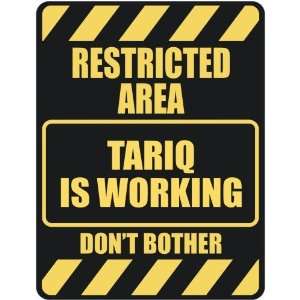   RESTRICTED AREA TARIQ IS WORKING  PARKING SIGN