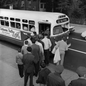  Line of Commuters Stepping Into Crowded Public Transit Bus 