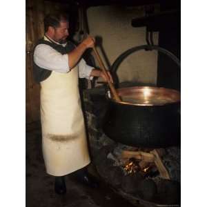  A Cheese Maker Stirs Milk in a Pot in Traditional Cheese Making 